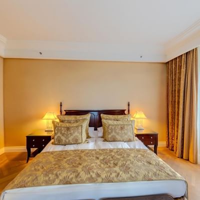 Large bed in Deluxe Room at Falkensteiner Hotels