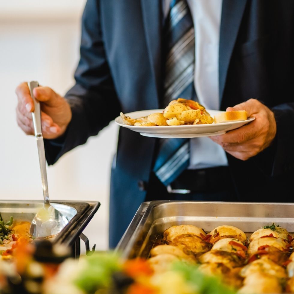 Gentleman in a tie at a buffet.