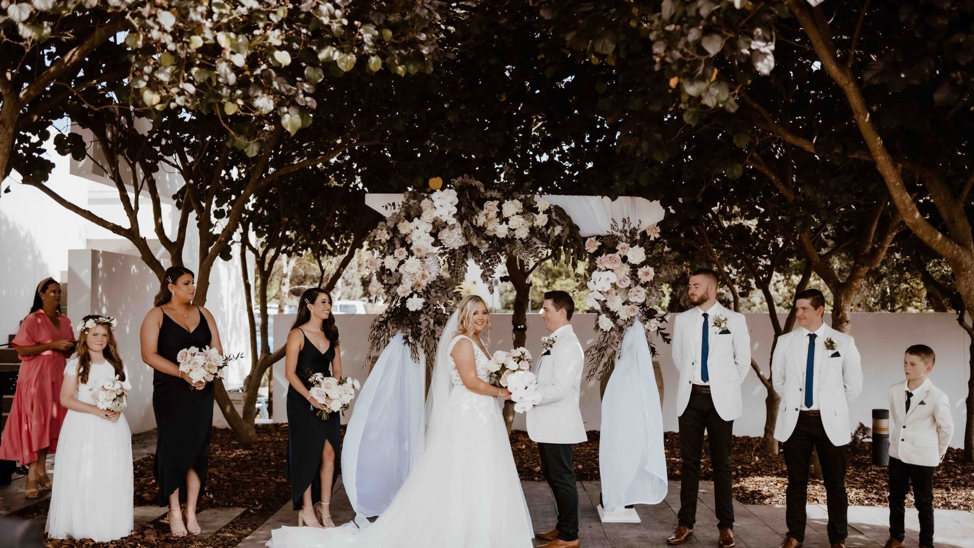 Floral wedding ceremony held outdoors at Pullman Magenta Shores