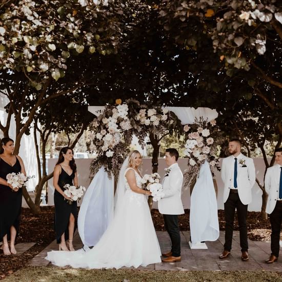 Wedding Ceremony in the garden area at Pullman Magenta Shores