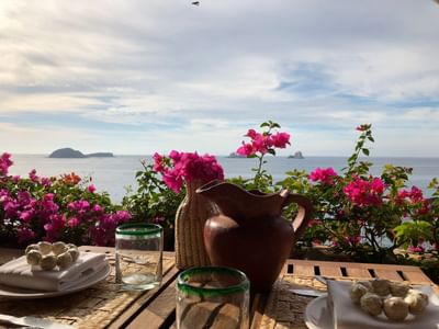 Dining table on a terrace with sea view at Cala de Mar