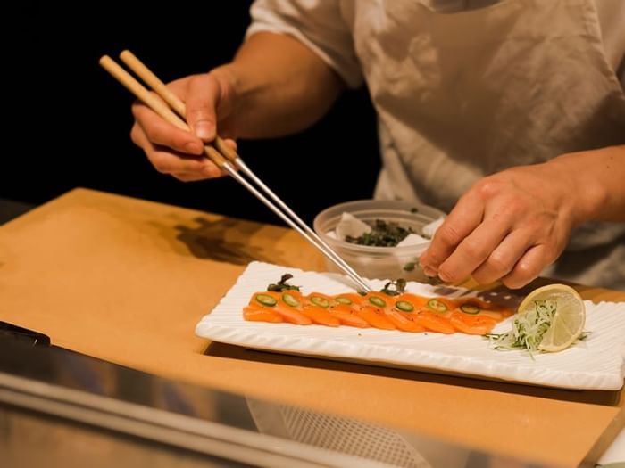 Male chef preparing sushi in the restaurant at Plymouth Hotel