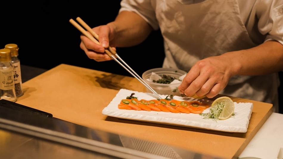 Male chef preparing sushi in the restaurant at Plymouth Hotel