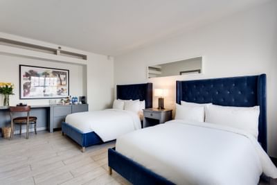 Double beds in Deluxe Pool View bedroom at Clinton Hotel South 