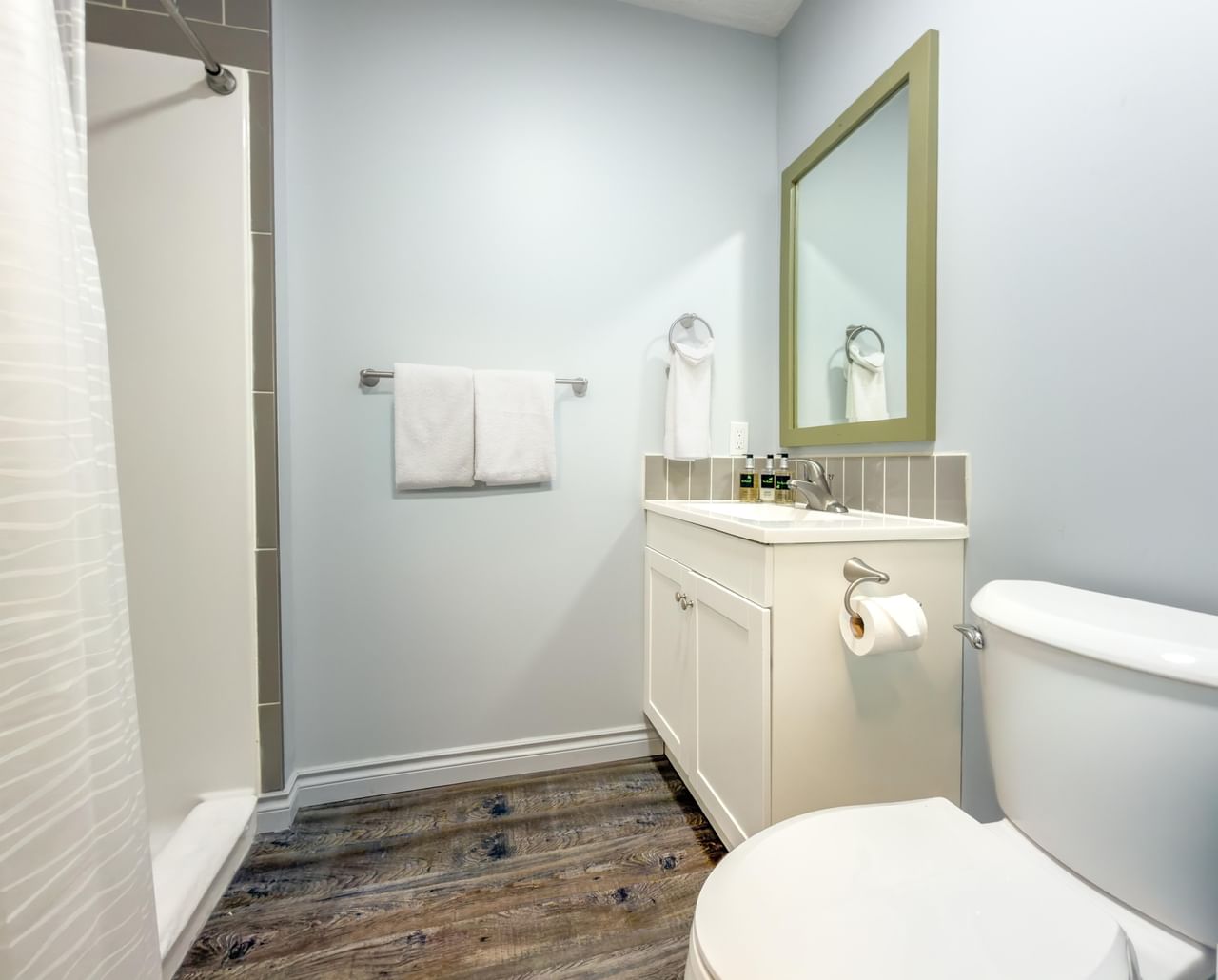 Bathroom at Coast Red Deer Hotel with vanity, toilet and shower