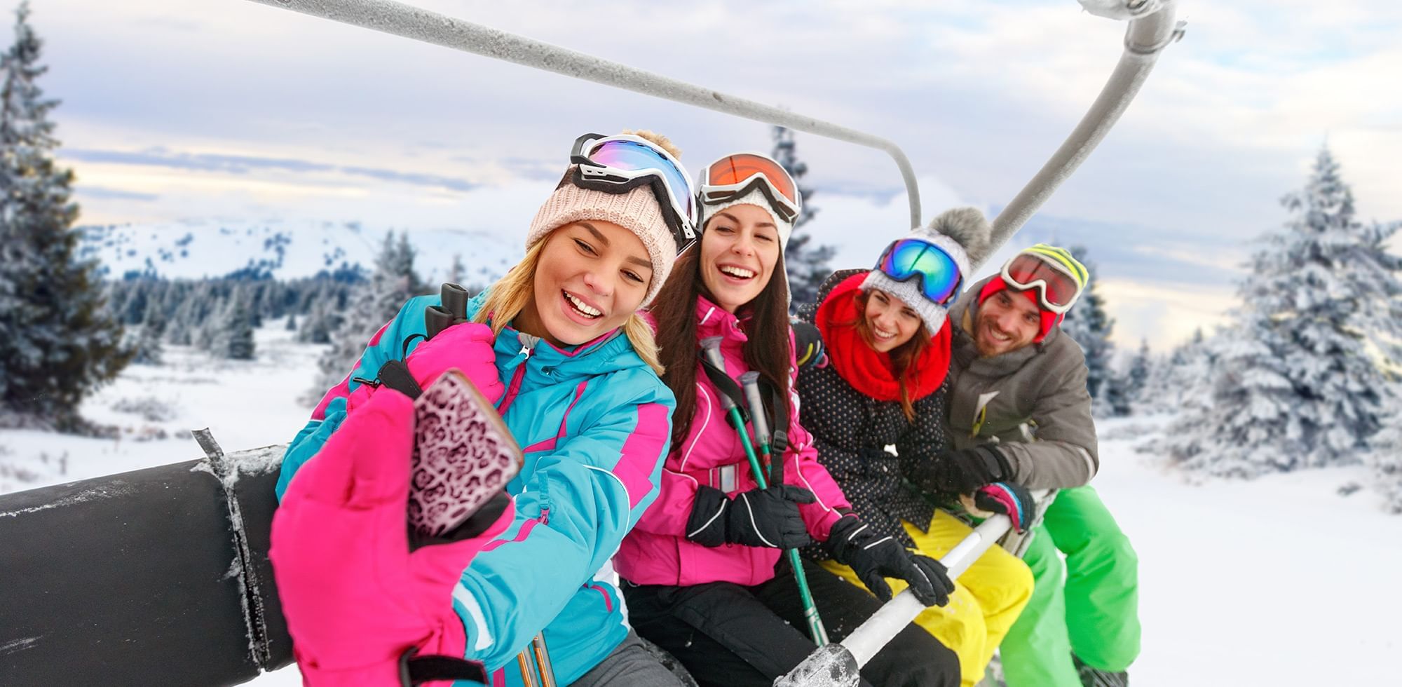 group of four skiers on a chairlift