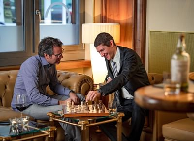Close-up of two gentlemen playing chess at Hotel Sternen
