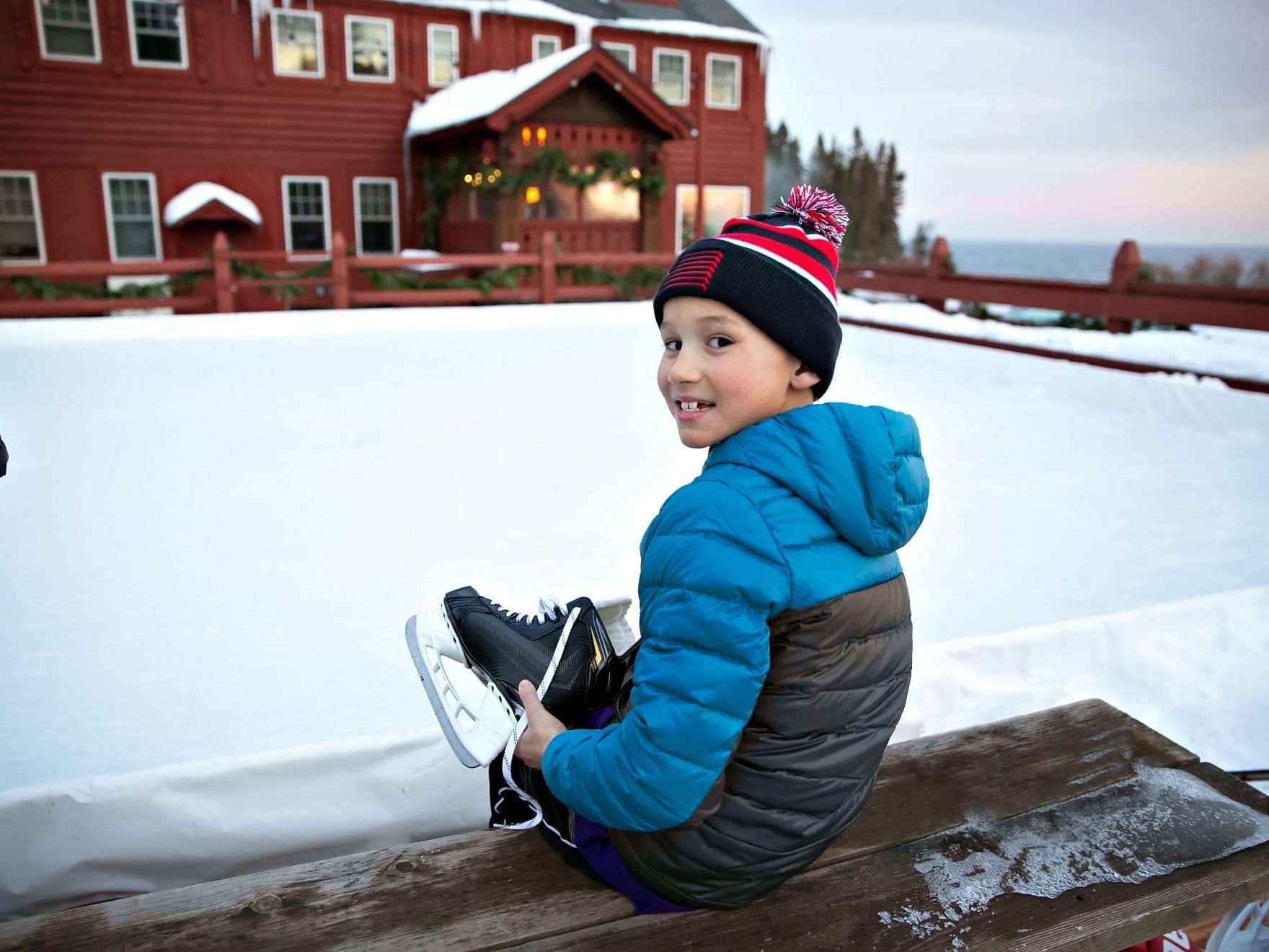 A kid sitting at the Ice Skating Rink in Lutsen Resort