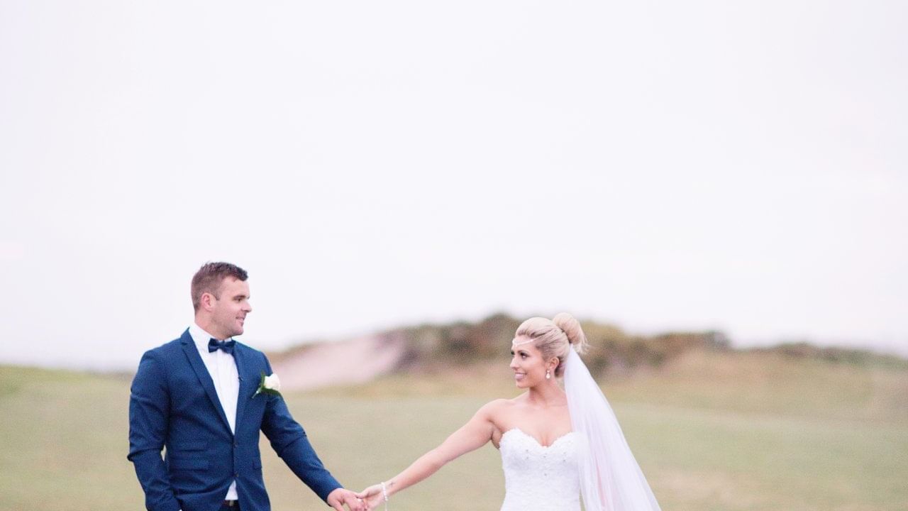 Wedding couple holding their hands at Pullman Magenta Shores