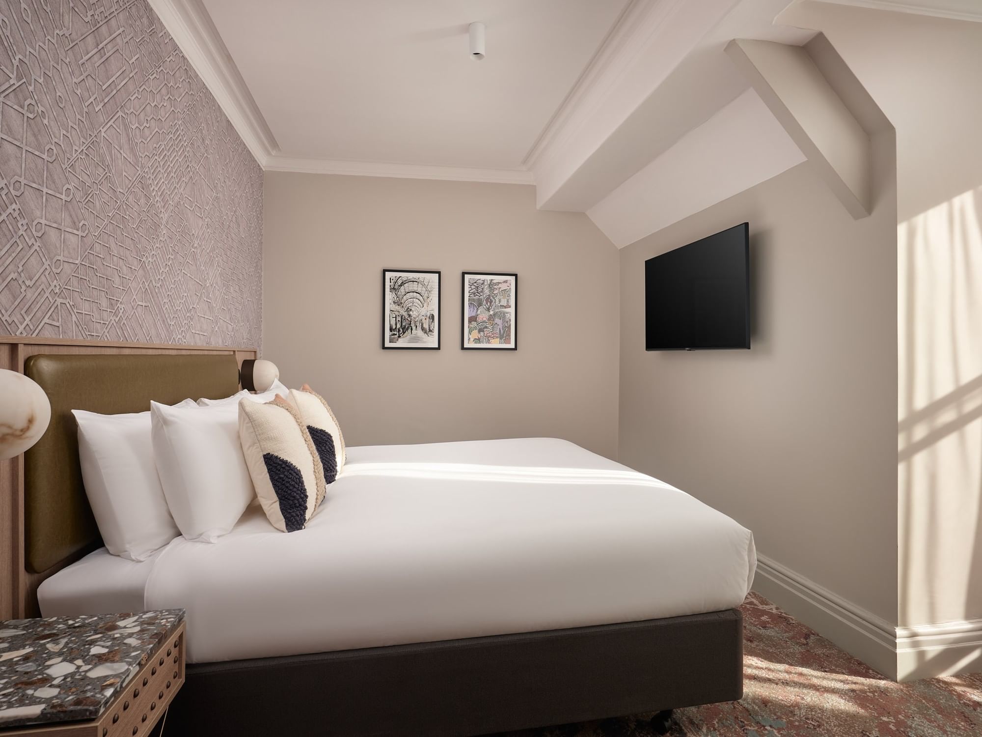 King-sized bed and wall-mounted television in a bright, stylish corner of Family Room at The Met Hotel Leeds, England