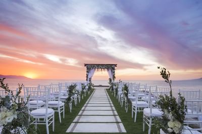 Seaside wedding dining setup at twilight at Villa Premiere Boutique Hotel & Romantic Getaway