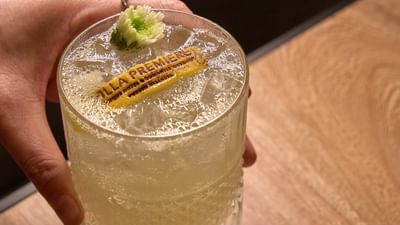 A refreshing handcrafted artisanal cocktail featuring creative garnishes served at an upscale resort bar.