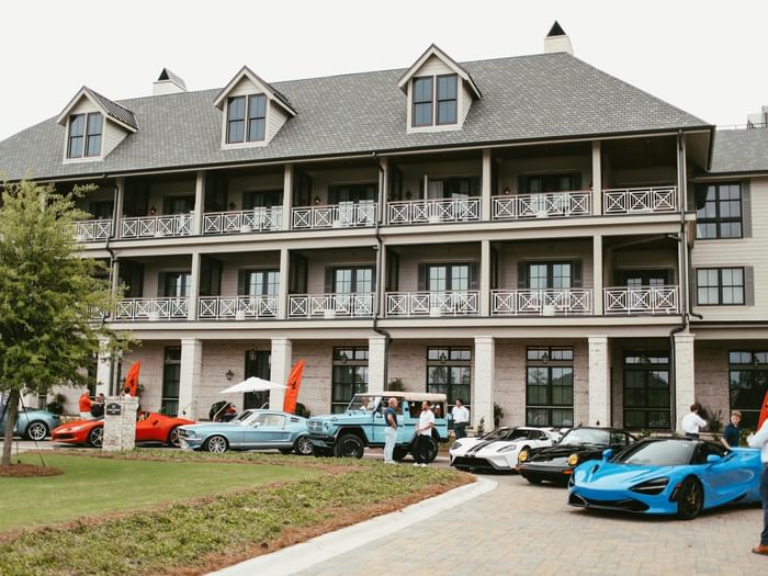 Luxury automobiles lined up in front of Camp Creek Inn for the Cars of 30A event