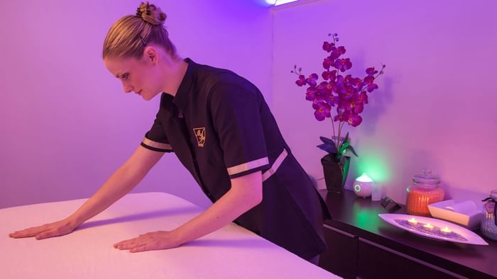 A Masseur making the spa bed in a Spa at Hotel du Pont Roupt