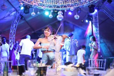 Lady performing violin in a function, Morgan Resort Spa Village
