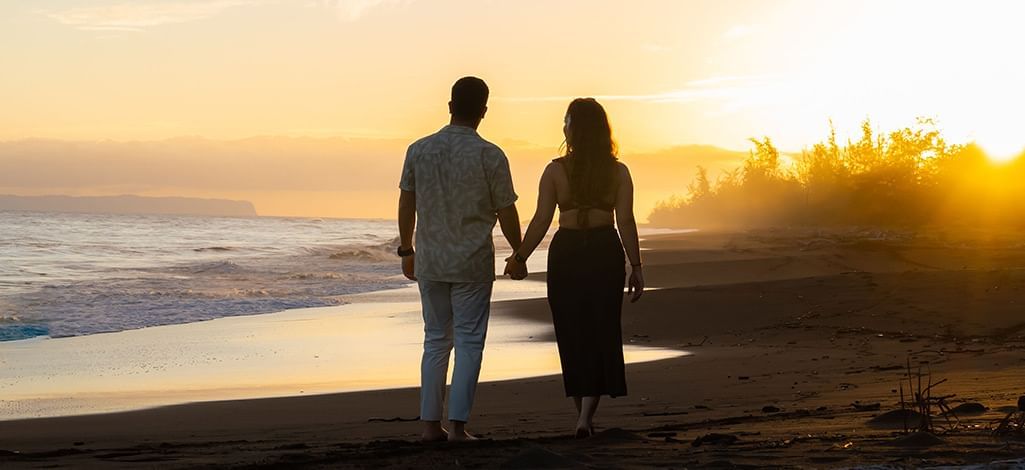 Couple strolling on a sunset beach   