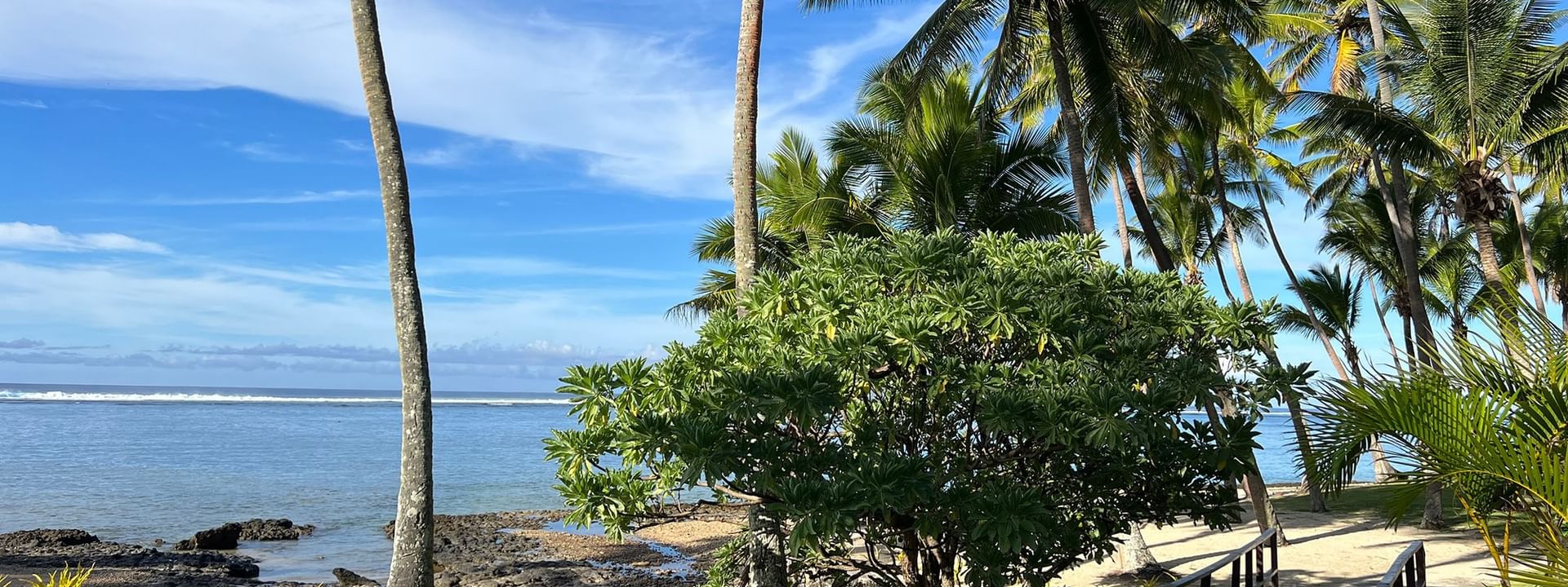 Wooden boardwalk leading to the beach at Tambua Sands Beach Resort in Sigatoka
