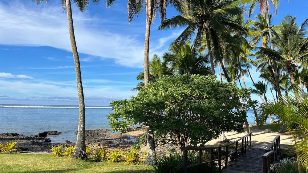 Wooden boardwalk leading to the beach at Tambua Sands Beach Resort in Sigatoka.