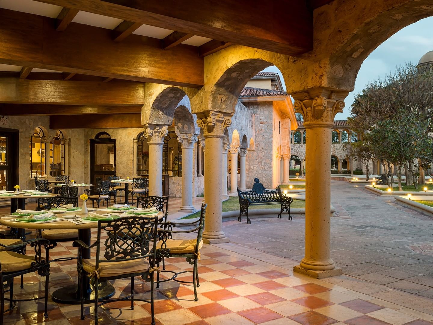 Tierra Mía restaurant features elegant arched stone architecture with outdoor dining tables overlooking a courtyard at Quinta Real Aguascalientes