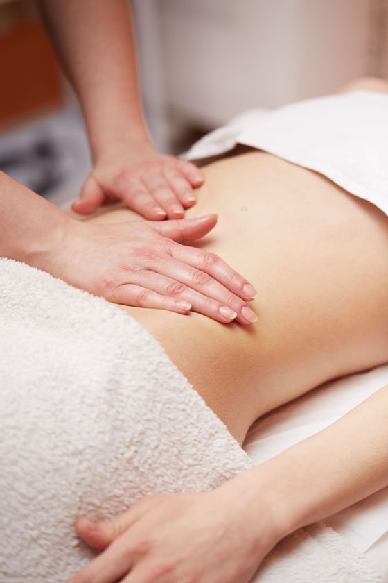 Close-up of an ongoing body massage in Liebes Rot Flueh's spa
