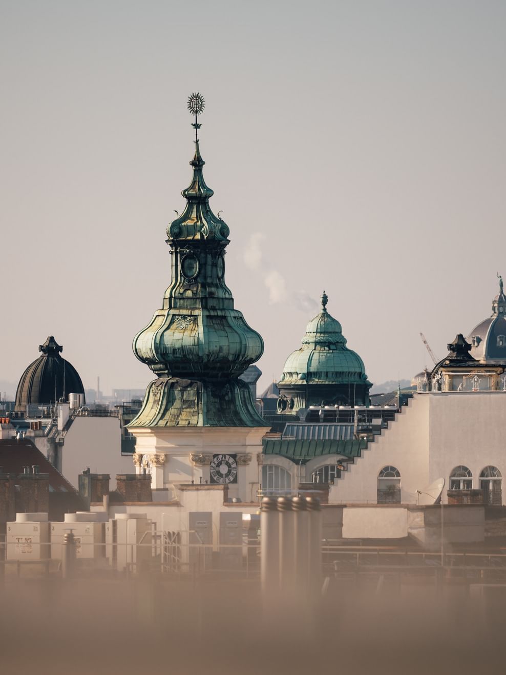 Copper green rooftops and spires against a blue sky near Almanac Palais Vienna featuring Vienna hotel deals