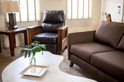 Cozy couch, coffee table & table lamp in Apartment 301 at Retro Suites Hotel