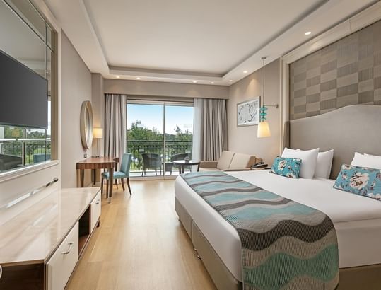 TV, sofa & work desk by the bed in Family Room at Titanic Deluxe Golf Belek