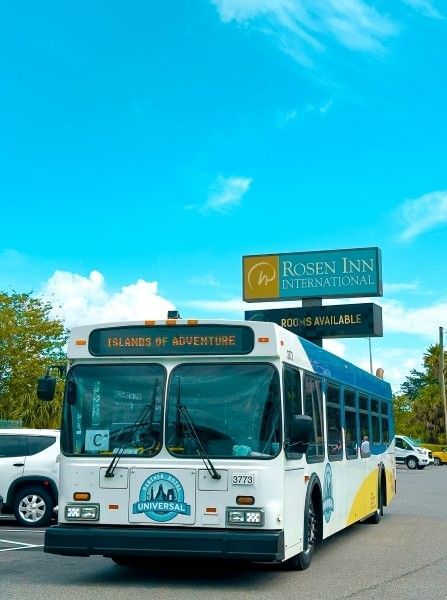A shuttle bus driving to Universal Orlando's Islands of Adventure Theme Park from Rosen Inn International, a family-friendly hotel near Orlando theme parks.