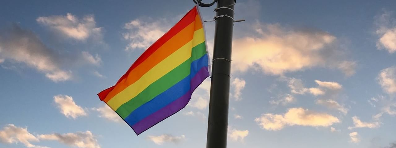 Pride flag waving from a lamp pole near Almanac X Alcron Prague, 5 star hotels in Prague