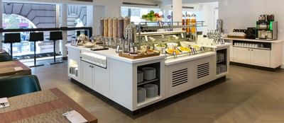 Dining area with food served at Hilton Paris Opera Hotel