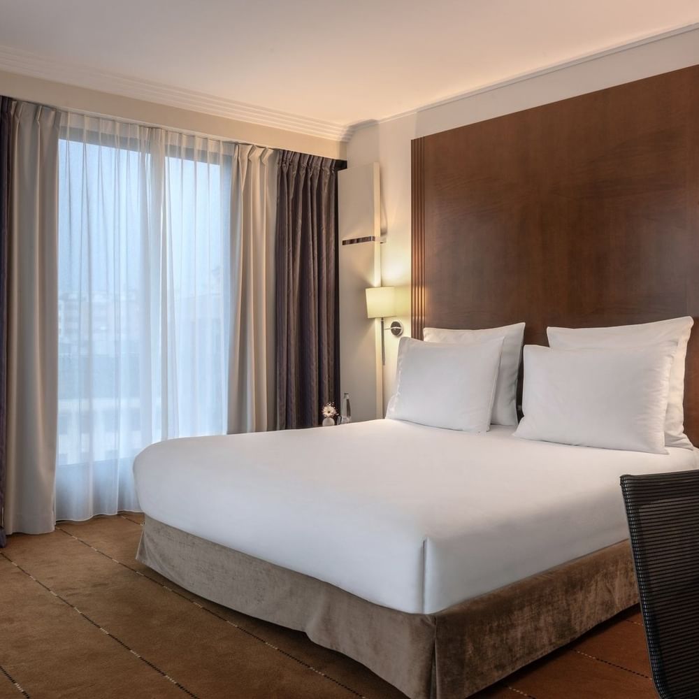 Family Room featuring a King bed by dark drapes surrounding large windows at Warwick Geneva