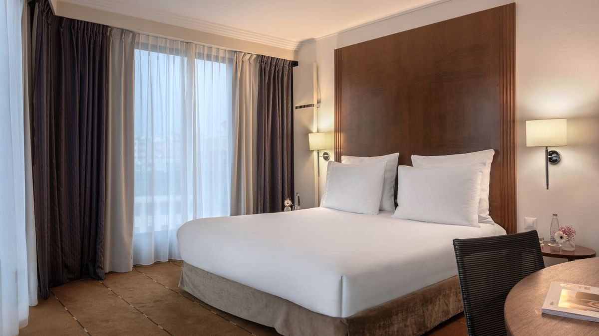 Family Room featuring a King bed by dark drapes surrounding large windows at Warwick Geneva