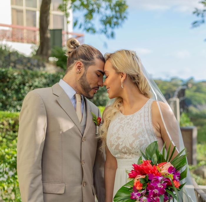 Wedded couple posing outdoors at Villas Sol Beach Resort