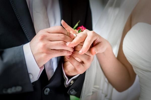 Bride and Groom exchanging rings during their marriage ceremony