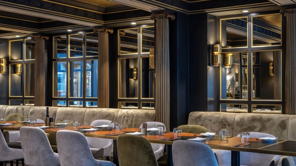 Long dining table set for a formal meal in the Restaurant & Bar at Hotel Barsey by Warwick 