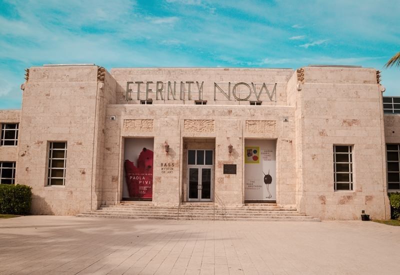 A beige stone building with a sign reading 'ETERNITY NOW' above the entrance.
