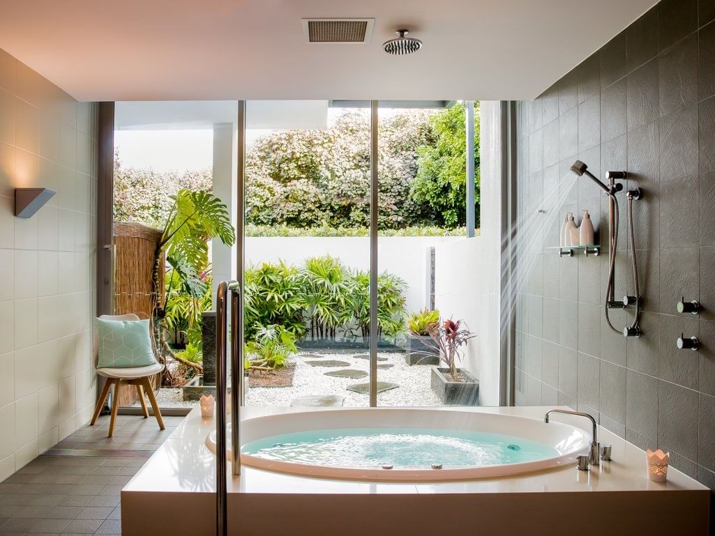 beautiful spa with bath that looks out over the luxury gardens
