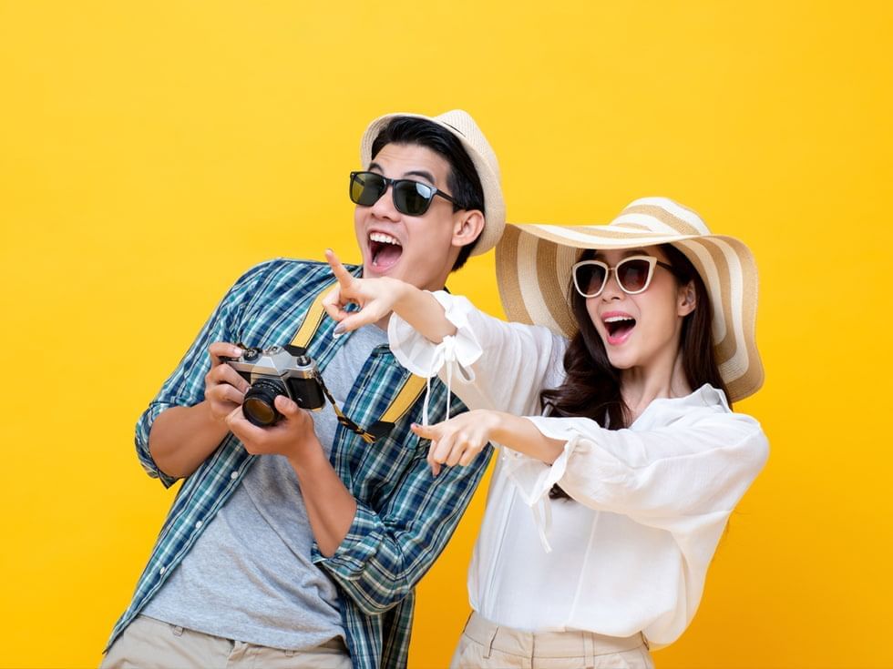 Couple in casual dresses pointing to something at Imperial Lexis Kuala Lumpur