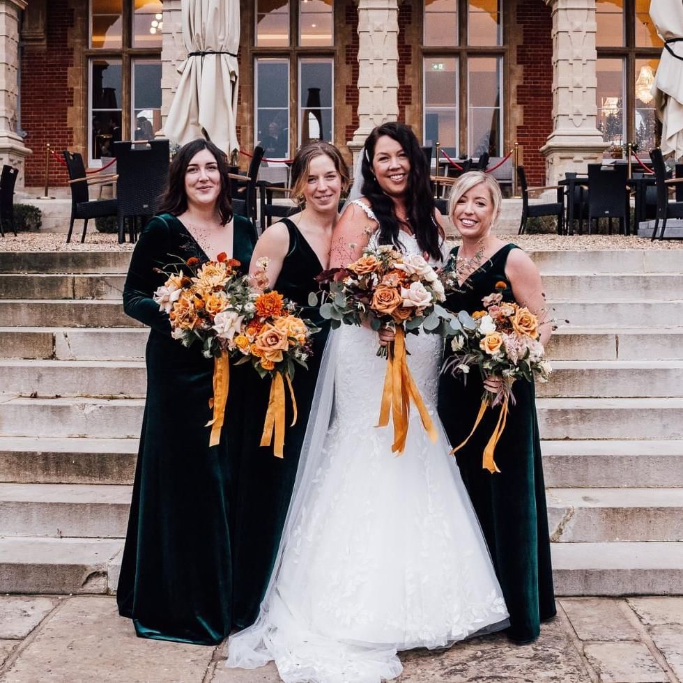 Bride with bridesmaids in front of Easthampstead Park in Berkshire