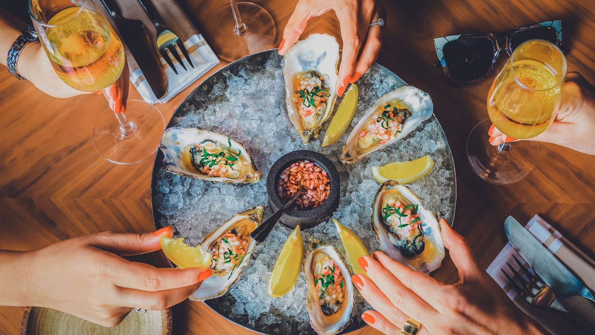 Oysters served with wine in Pacific Groove Restaurant & Lounge at Paramount Hotel Dubai