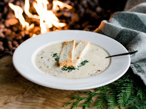 A bowl of soup served with bread at Alderbrook Resort & Spa