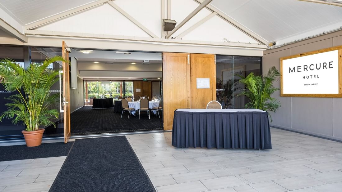 Entrance of Burdekin Room featuring open doors and a reception desk at Mercure Hotel Townsville