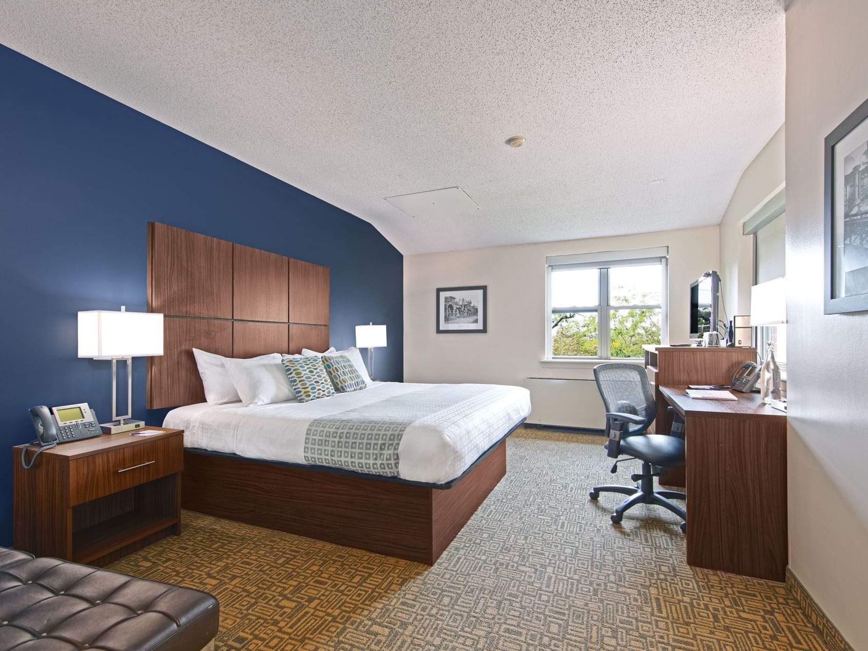 Bed & desk in Standard King room at Kellogg Conference Center