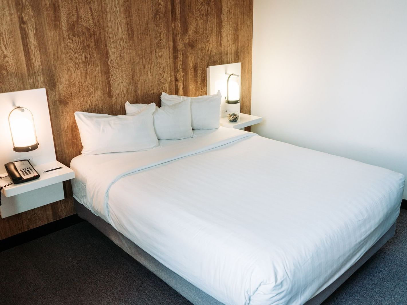 Cozy white bed in hotel room