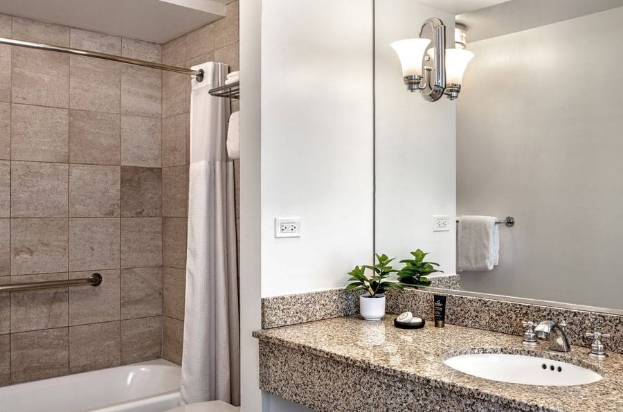 Executive King bathroom featuring marble vanity by the bathtub at Warwick Allerton Chicago