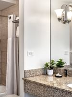 Standard Room bathroom featuring marble vanity by the bathtub at Warwick Allerton Chicago