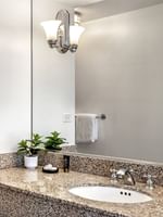 Executive King bathroom featuring a marble vanity by the bathtub at Warwick Allerton Chicago