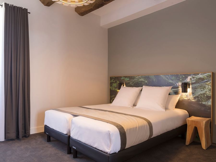 Triple room with king size bed at The Originals Hotels