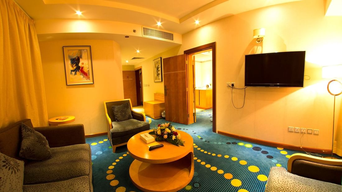 Sitting area featuring TV & couches in Junior Suite at Dabab Hotel by Warwick - Riyadh