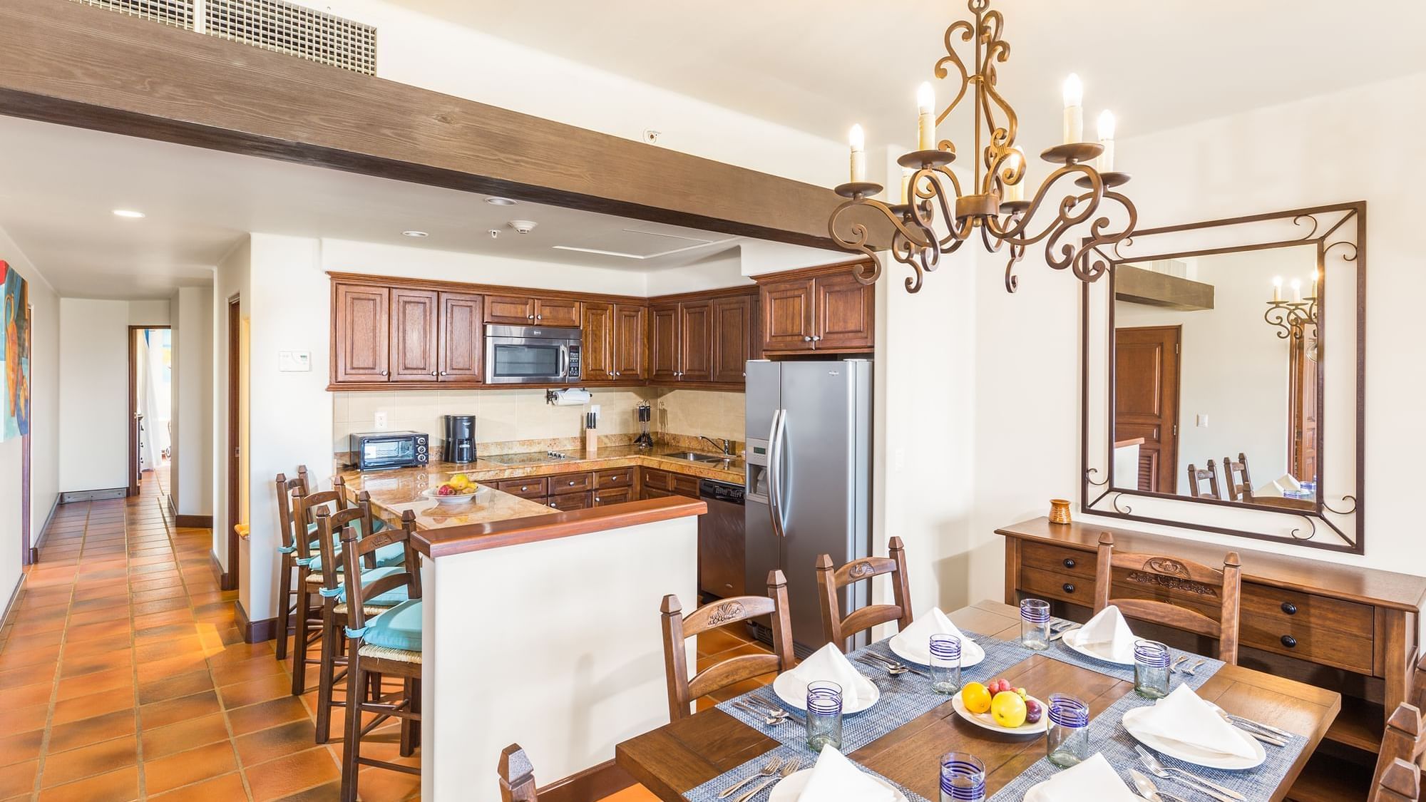 Dining area with chandelier and full kitchenette with cabinets in the Three Bedroom Villa at Hacienda Del Mar Los Cabos